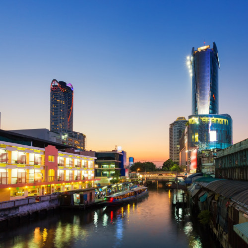 Skyscraper and Pratunam pier in Bangkok; water transportation by speed boat is one of the alternative choice for solving the traffic congestion problem in Bangkok.